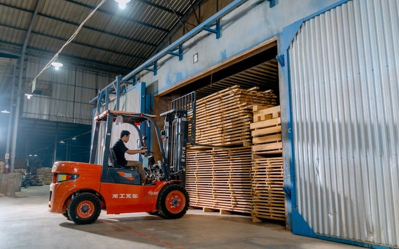 Forklift moving pallets in an active logistics warehouse