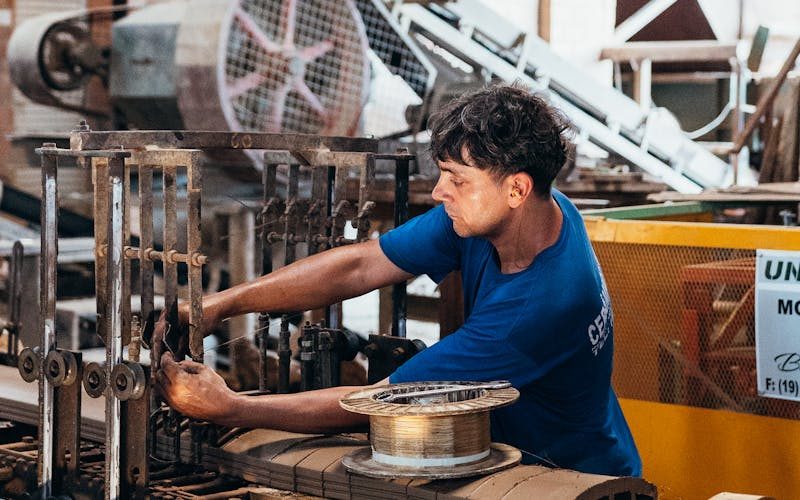 Production operator using a tablet at the work station