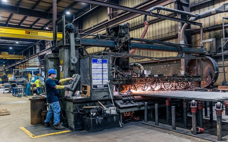 Production worker operating machinery on a factory floor